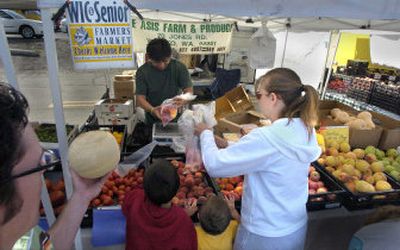 
Scott, left, and Nicole Rainsberry shop with their three kids Wednesday at the Spokane Farmers' Market, on Second Avenue between Division and Browne. They are using the WIC program to get fresh fruit and vegetables. 
 (Christopher Anderson/ / The Spokesman-Review)
