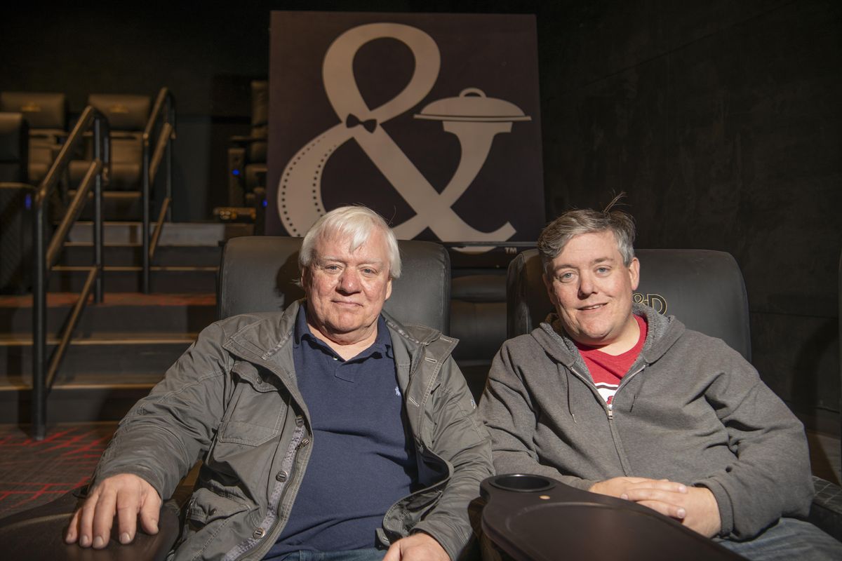 Larry Jacobson, founder of CineGenesis, and his son, Spencer Jacobson, Vice President of Operations of CineGenesis, sit in one of the new theaters at Dinner and Movie, an 8-theater cineplex next to Northern Quest Casino. Larry Jacobson, working at AMC other industry giants as well as CineGenesis, has introduce many innovations in the theater industry, including things like cupholders, stadium seating and digital projectors inside the theater, not to mention the dinner/theater concept. Photographed Monday, Oct. 1, 2018. Larry worked for AMC and other entities in the movie industry and is credited with innovations like cup holders, stadium seating and some digital projection innovations. (Jesse Tinsley / The Spokesman-Review)