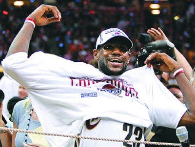 
LeBron James tries on his conference championship T-shirt.
 (Associated Press / The Spokesman-Review)