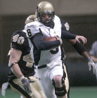 
Quarterback Steve Wichman escapes the pocket. 
 (Joe Barrentine The Associated Press / The Spokesman-Review)