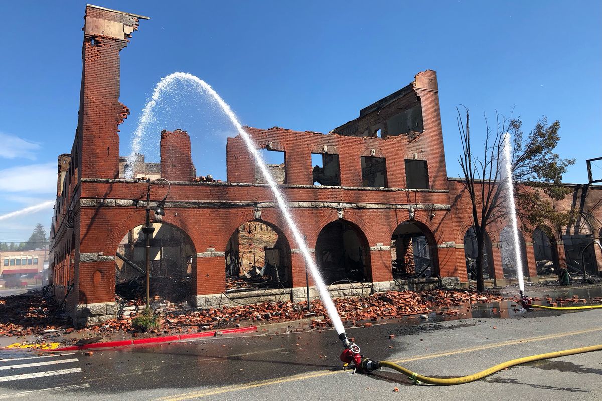 The smoking remains of Sety’s Ace Hardware is doused with water Friday morning in Chewelah, Wash.  (DAN PELLE/THE SPOKESMAN-REVIEW)