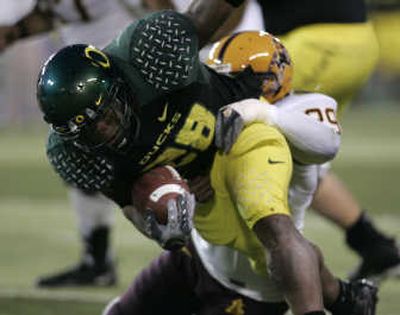 
Oregon's Jonathan Stewart, left, struggles for yardage against ASU defender Brett Nenaber.Associated Press
 (Associated Press / The Spokesman-Review)