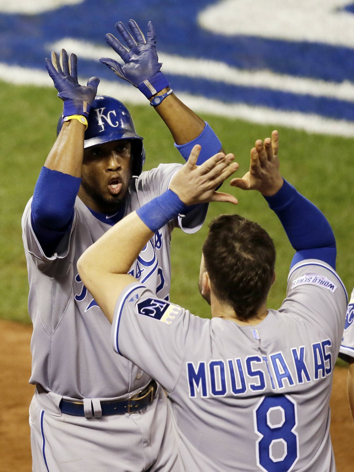Alcides Escobar, Mike Moustakas celebrate. (Associated Press)