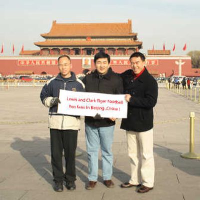 
From left, Leonard Wang, Tony Zhao and Louie Niu hold a banner supporting Lewis and Clark football in Tiananmen Square, China. Photo courtesy of Rene Miller
 (Photo courtesy of Rene Miller / The Spokesman-Review)