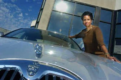 
Jan Richardson is the new owner and operator of the Spokane Jaguar, Land Rover and Volvo dealership. She is shown standing behind her product at the west Third dealership. 
 (Christopher Anderson / The Spokesman-Review)