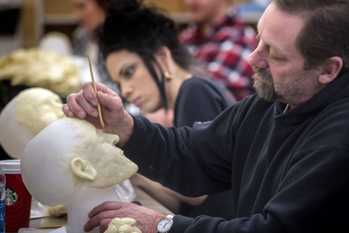 Charlie Turner, of Coeur d’Alene, right, and Samantha Foster, of Mukilteo, Washington, re-create faces at Lake Washington Institute of Technology in Kirkland. The course is part of a two-year funeral services program which expects to graduate 22 students this year.