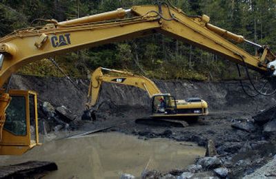 
John Willey of B&W Excavating clears part of the Cedar Creek Dam on Tuesday. The 19-foot -high dam has not been used to create a water source for  Ione in over 20 years. 
 (Kathy Plonka photos/ / The Spokesman-Review)