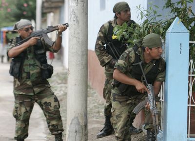 Police take positions as they wait for Amazon Indians hiding in the patio of a public hospital to come out in Bagua Grande, Peru, Saturday.  (Associated Press / The Spokesman-Review)