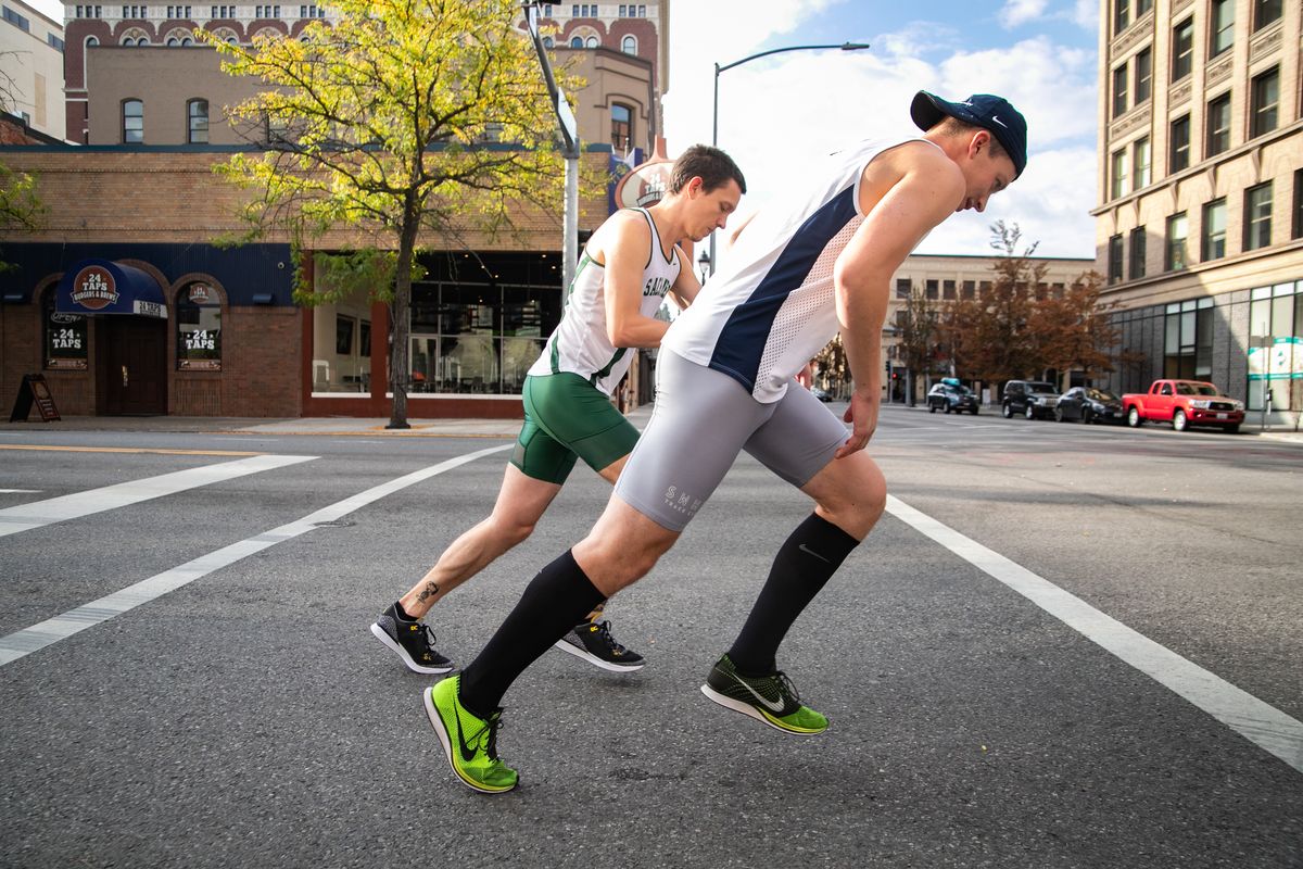 Steven Kutsch and Tate Kelly start their Virtual Bloomsday together at Riverside and Lincoln near where the traditional start line would have been on Sunday, Sept. 20, 2020, in Spokane. The original May race was rescheduled to Sept. 20 due to COVID-19 before being canceled altogether in favor of the virtual race, which could be completed anywhere in the world to allow for social distancing.  (Libby Kamrowski/The Spokesman-Review)