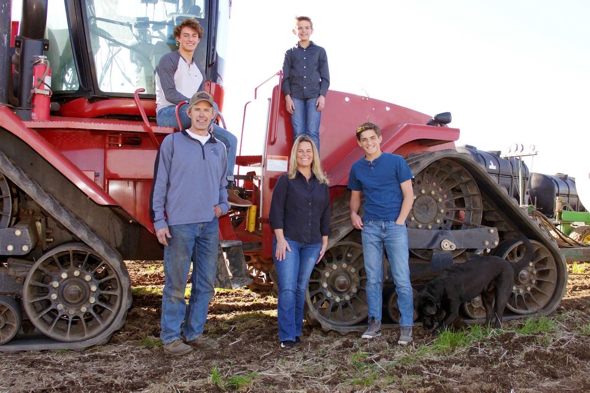 Eric Odberg, lower left, is seen with his family on their farm April 19, 2018, near Genesee, Idaho. Odberg is the fourth generation to work the ground on the property, which just received a century farm designation. (Kai Eiselein / The Moscow-Pullman Daily News)