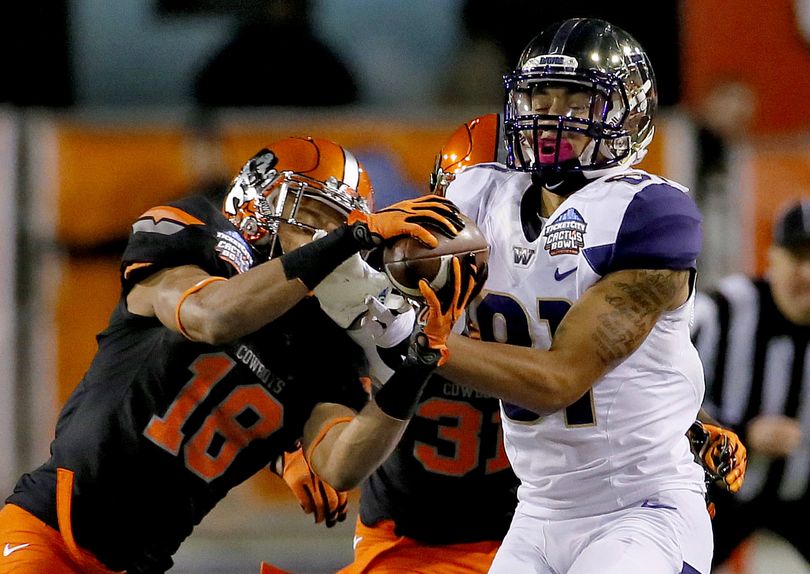 Oklahoma State cornerback Ramon Richards, left, breaks up a first-half pass intended for Washington wide receiver Brayden Lenius. (Associated Press)