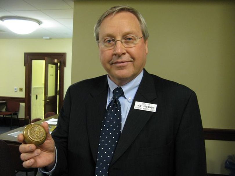 Sen. Joe Stegner, R-Lewiston, displays an antique doorknob - an original from the state Capitol - that was anonymously left in a box on his desk. Many of the heavy brass doorknobs, heavily etched with the state seal, disappeared over the years. Stegner said he intends to get it back on a Statehouse door. (Betsy Russell)