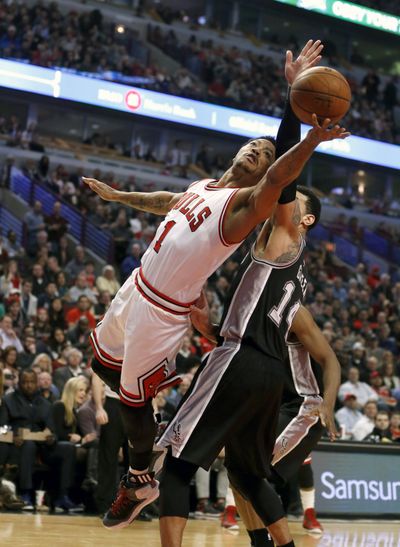 Derrick Rose, left, hit 9 of 16 shots in Bulls’ 104-81 win over Spurs. (Associated Press)