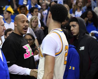 In this March 4, 2017, file photo, UCLA guard Lonzo Ball, right, shakes hands with his father LaVar following an NCAA college basketball game against Washington State in Los Angeles. The outspoken father of former UCLA star Lonzo Ball said Wednesday, May 17, on Fox Sport 1’s “The Herd with Colin Cowherd” that it will now cost a shoe company $3 billion to make a deal with his Big Baller Brand. (Mark J. Terrill / Associated Press)