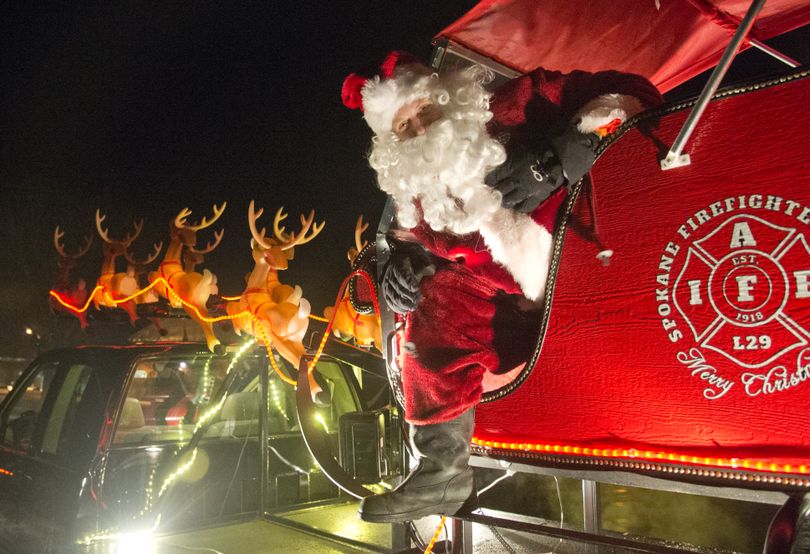 Santa Clause, played by firefighter Russ Reser, poses for a photo Wednesday, Dec. 16, 2015 on the truck-mounted sleigh which volunteers from the firefighter's union use to carry Santa through Spokane neighborhoods.  The truck-mounted Santa has been going on tours around the city for more than 50 years. (Jesse Tinsley / The Spokesman-Review)
