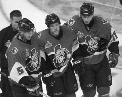 
Ottawa's Dean McAmmond, center, is helped off the ice after a hit from Anaheim's Chris Pronger Saturday.
 (Associated Press / The Spokesman-Review)