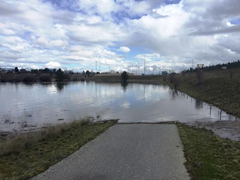 The Spokane River Centennial Trail is inundated by flood waters near the Interstate 90 weigh station in Spokane Valley on March 22, 2017. (Russ Naber)