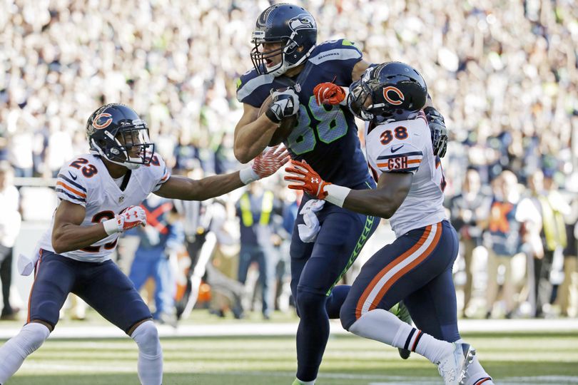 Seahawks tight end Jimmy Graham plows through Bears Adrian Amos, right, and Kyle Fuller to score on a pass from Russell Wilson in the second half. (Associated Press)
