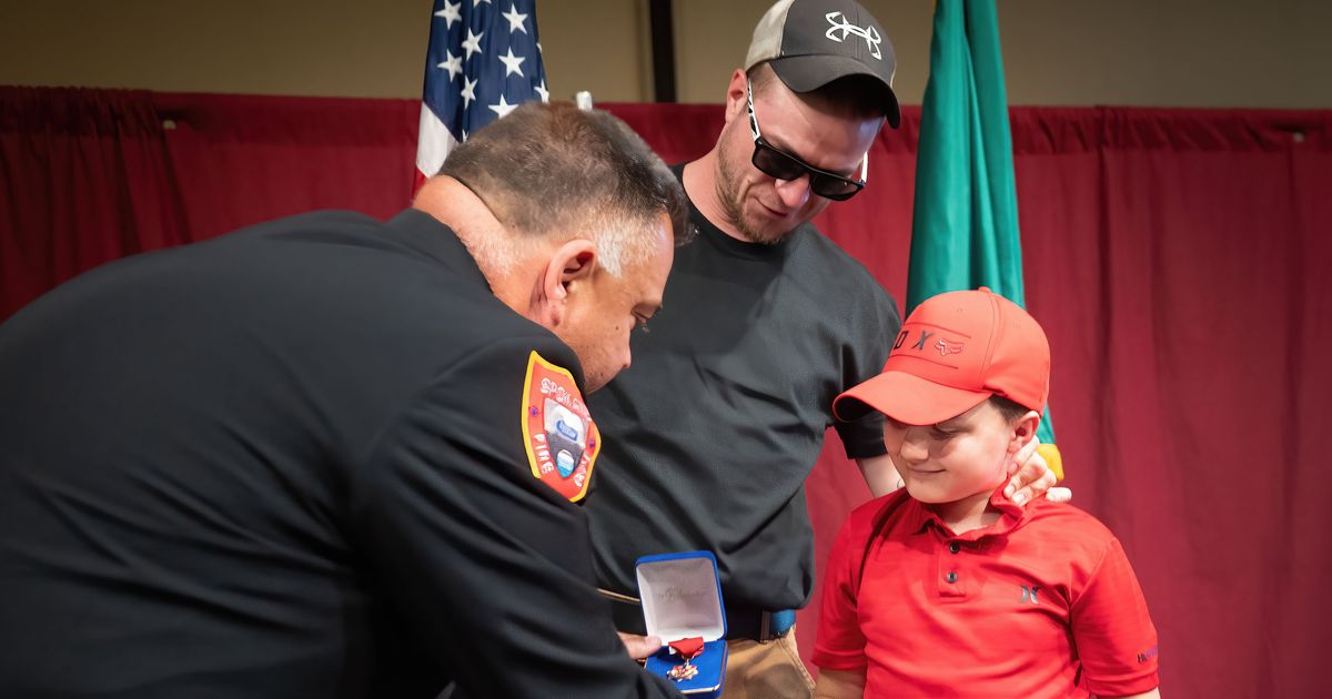 'He did everything himself': 7-year-old saves father's life with 911 call, honored by firefighters