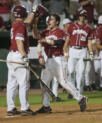 Derek Jones, left, high-fives Jay Ponciano, who comes home on a two-run homer by Cody Bartlett.  (Associated Press)