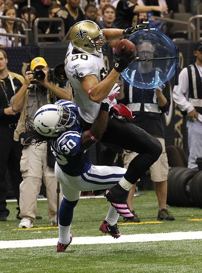New Orleans tight end Jimmy Graham scores a touchdown against Indianapolis safety David Caldwell. (Associated Press)