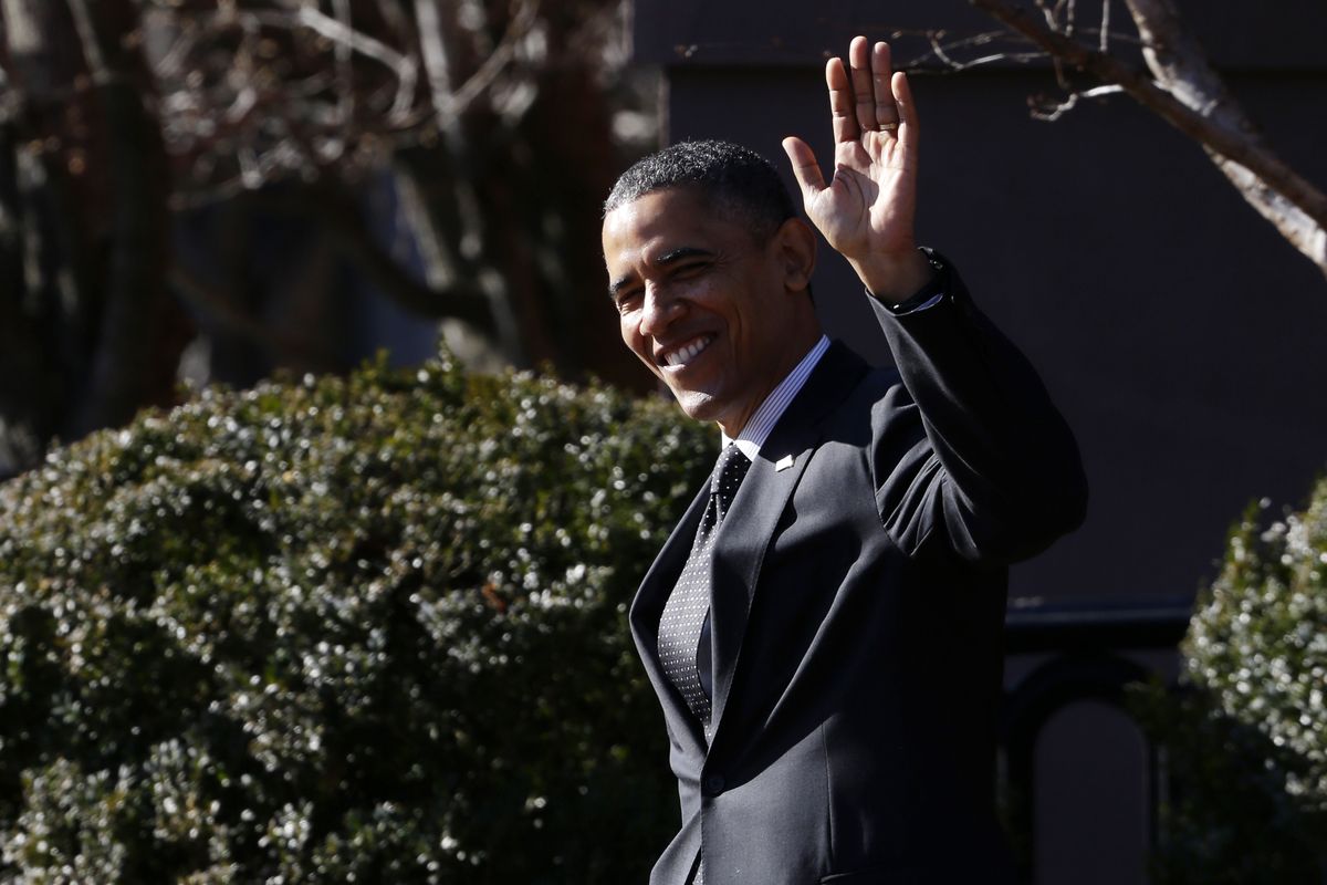 President Barack Obama waves to reporters as they shout questions to him regarding the fiscal cliff as he walks across Pennsylvania Avenue back to the White House in Washington, Thursday, Dec. 13, 2012. Obama had dropped by a holiday party for the National Security Council at Blair House. (Charles Dharapak / Associated Press)