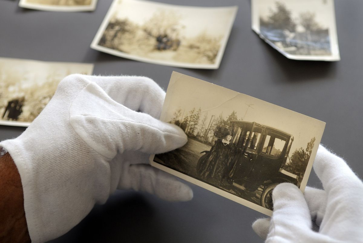Don Beaty holds a photograph of Jessie Nuzum and her car taken in 1923. It’s his favorite of 10 he donated to the Northwest Museum of Arts and Culture.  (Photos by Dan Pelle / The Spokesman-Review)