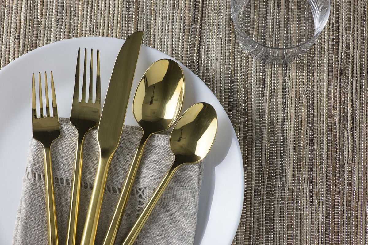 Raise the bar further with real plates, glasses, silverware and napkins from affordable sources, with a natural fiber and Lurex table runner. (Jennifer Chase / The Washington Post)