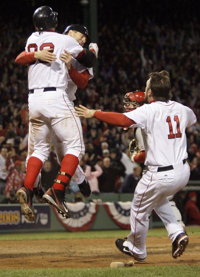 Jason Varitek, left, and Jason Bay celebrate Bay’s winning run.  (Associated Press / The Spokesman-Review)