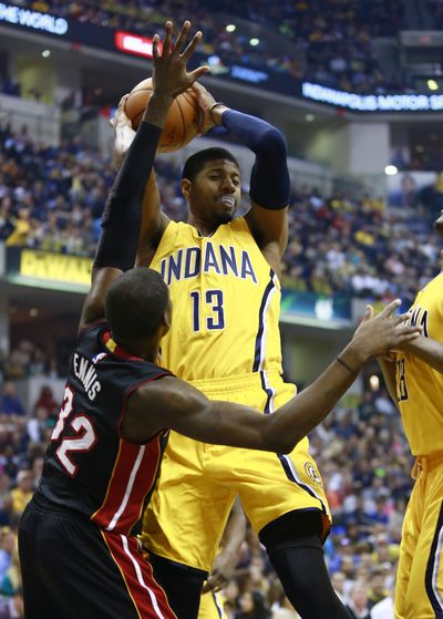 Indiana forward Paul George (13) pulls down a rebound against James Ennis of Miami in George’s first game back from broken leg. (Associated Press)