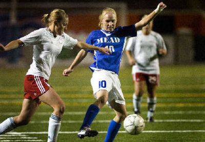 
Ferris' Danielle Raczykowski, left, defends against Mead's Kristen Bussard in district title match. 
 (Holly Pickett / The Spokesman-Review)