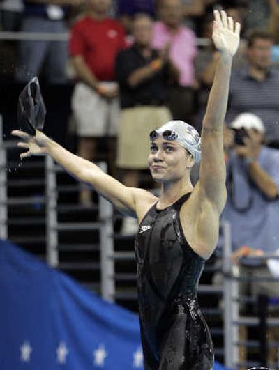 Natalie Coughlin waves as she leaves the pool after winning the women's 100-meter backstroke in world-record time on Tuesday. Associated Press
 (Associated Press / The Spokesman-Review)