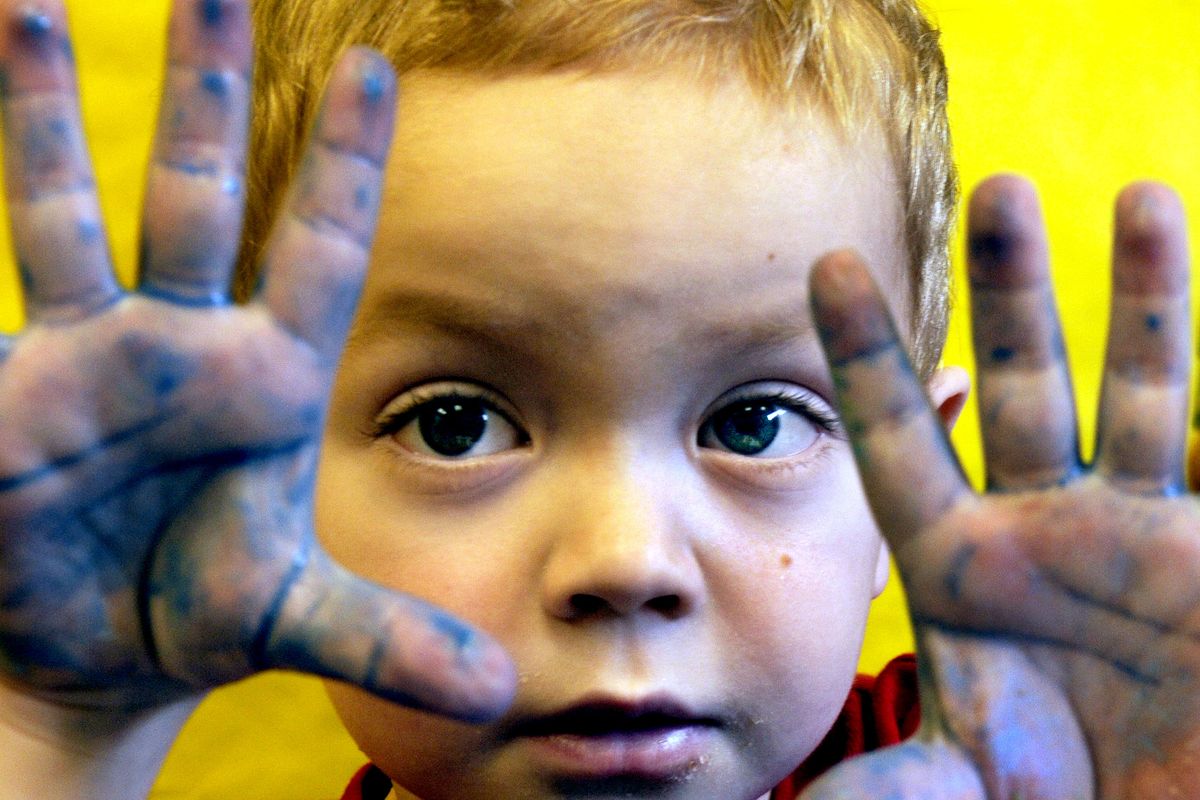 Preschooler Henry Sturgis shows off his hands after finishing an art project at Little Sprouts Preschool in Sandpoint. A rare disease called cystinosis, which affects only 500 people in the  country, afflicts Henry. (Kathy Plonka)