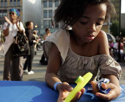 
Karnisha Griffin ponders her instrument before a failed attempt to set a new  world record for assembled kazoo players Thursday in the Harlem neighborhood of New York. Associated Press
 (Associated Press / The Spokesman-Review)