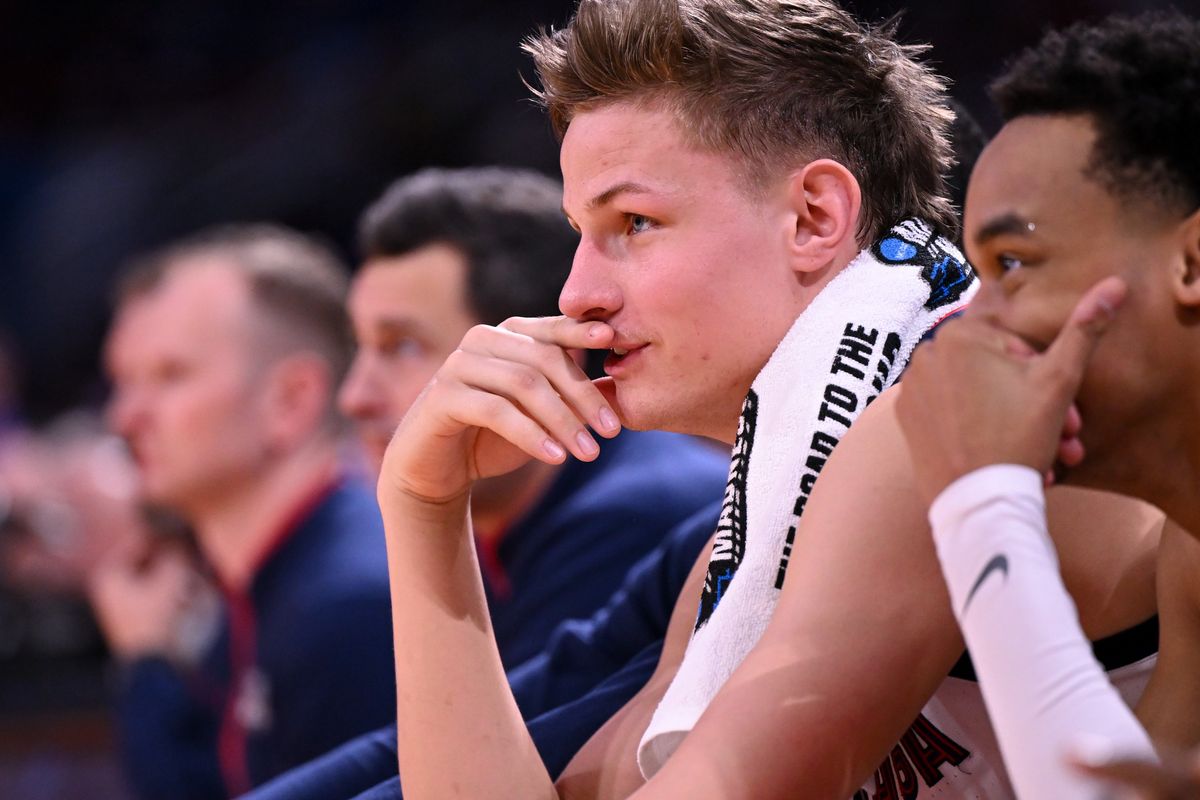 Gonzaga forward Ben Gregg smiles on the bench during the first half of the Zags