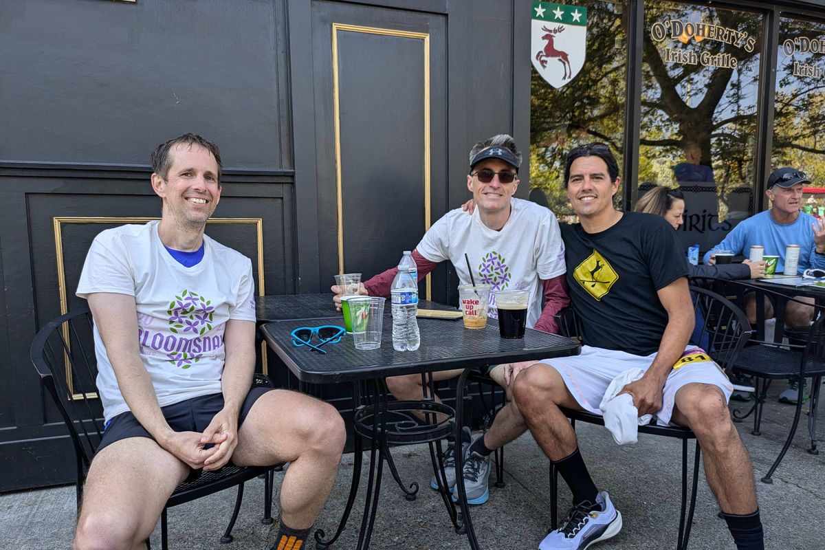 Matthew Kee, left, Kevin Boerker and Billy Morse celebrate finishing another Bloomsday with a cold drink.  (Emry Dinman/The Spokesman-Review)