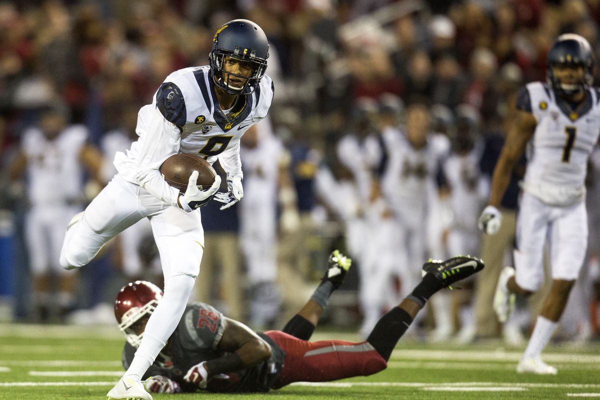 California wide receiver Trevor Davis (9) regains his balance after jumping over WSU’s Darius Lemora on a touchdown run. (Associated Press)