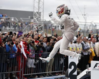 Mercedes driver Lewis Hamilton, of Britain, celebrates after winning the world championship with his victory at the Formula One U.S. Grand Prix auto race at the Circuit of the Americas, Sunday, Oct. 25, 2015, in Austin, Texas. (John Locher / Associated Press)