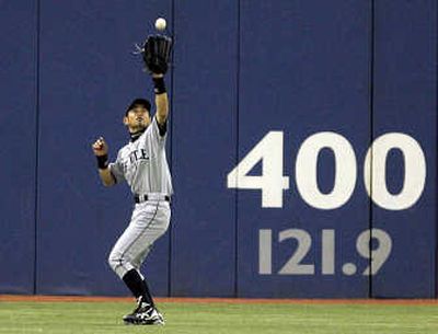 
Ichiro Suzuki catches a fly, but three others by Jays left the park.Associated Press
 (Associated Press / The Spokesman-Review)