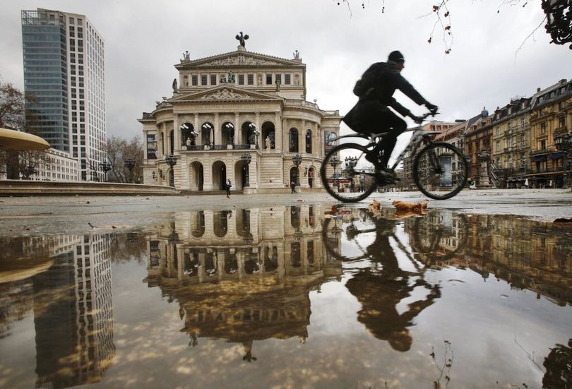 A man on a bicycle passes by the Old Opera that is reflected in a puddle on a rainy day in Frankfurt, Germany, Jan. 13, 2016. If he were in Missouri, he might need a really tall orange flag.  (AP Photo/Michael Probst)