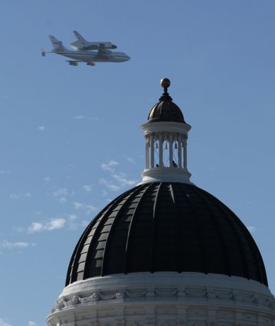 The space shuttle Endeavour passes over the California state Capitol, Friday, Sept. 21, 2012,  in Sacramento, Calif. Endeavour is making a final trek across the country to the California Science Center in Los Angeles, where it will be permanently displayed. (Rich Pedroncelli / Associated Press)