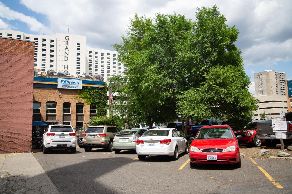 Dan Hall, director of downtown security ambassadors & clean team, points out areas that could see improvements in an area behind the American Legion Building in downtown Spokane on July 8, 2019. Thick vegetation and limited lighting in areas such as these are taken advantage of for illegal activities. (Libby Kamrowski / The Spokesman-Review)