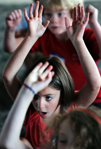 Within their reach: Olivia Jacobsen, 7, center, performs along with her fellow campers at Christian Youth Theater-North Idaho Summer Camp on Tuesday at Lake City Community Church in Coeur d’Alene. (Kathy Plonka)