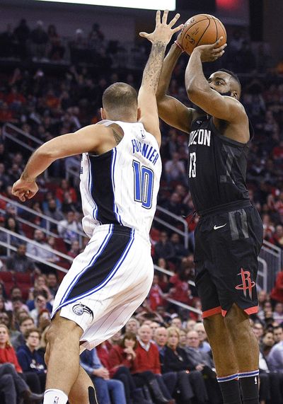 Houston Rockets guard James Harden, right, shots a 3-pointer as Orlando Magic forward Evan Fournier defends during the second half of an NBA basketball game Tuesday, Jan. 30, 2018, in Houston. Houston won 114-107. (Eric Christian Smith / Associated Press)