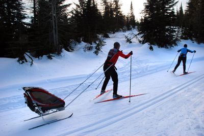 Eric Anderson of Spokane follows his wife, Amy, while skating the Mount Spokane nordic trails with their baby, Kate, snug as a bug in the trailer even though the temperature was in the teens.  (Photos by RICH LANDERS / The Spokesman-Review)
