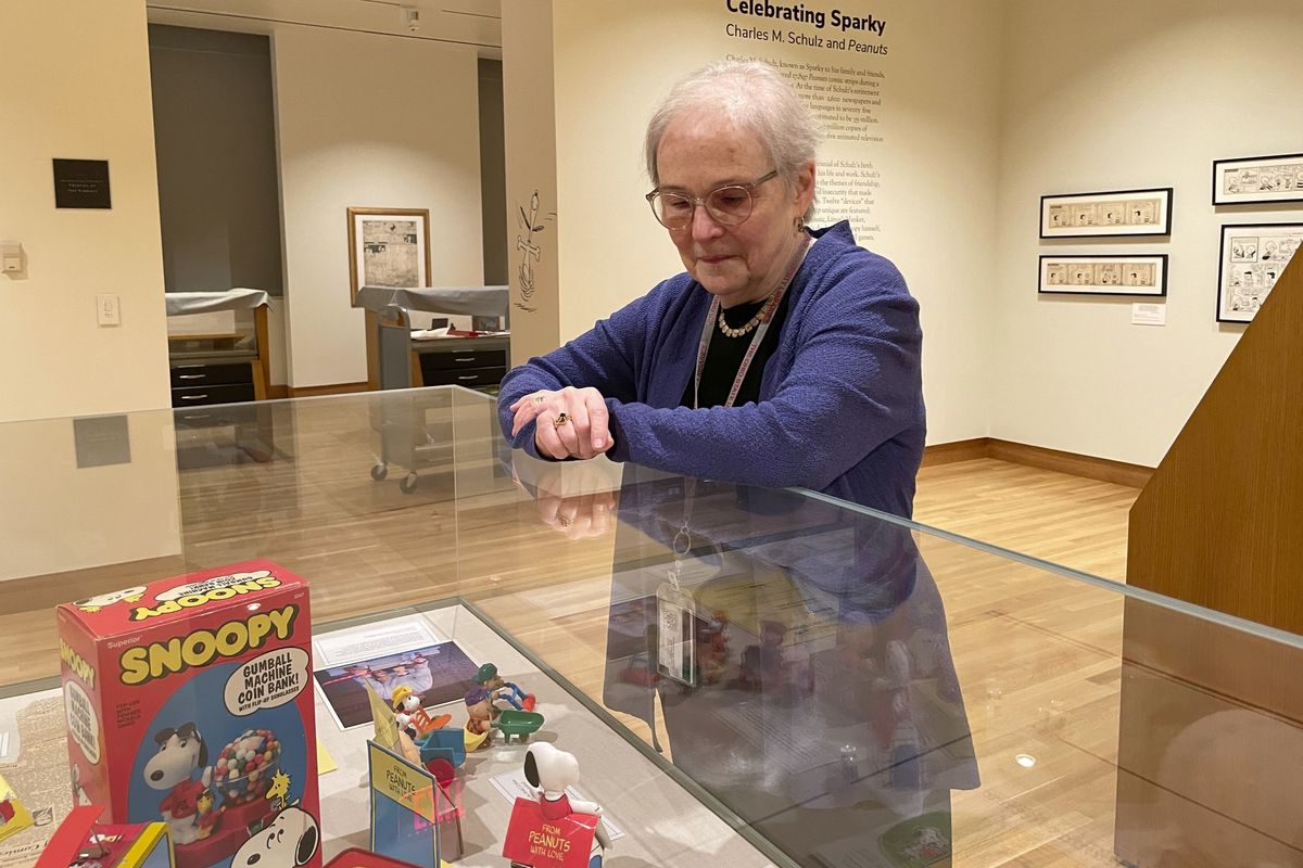 Lucy Shelton Caswell, founding curator of the Billy Ireland Cartoon Library Museum, examines memorabilia tied to the comic strip “Peanuts” on May 20 in Columbus, Ohio.  (Patrick Orsagos)