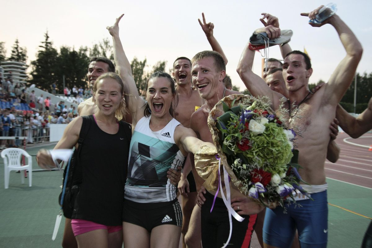 Russia’s pole vaulter Yelena Isinbayeva, second left, poses with her teammates at the National track and field championships at a stadium in Cheboksary, Russia, Tuesday, June 21, 2016. The IOC opened the door to some Russian athletes competing under the Russian flag in Rio, but it is not clear what exact conditions they must fulfill. (Nikolai Alexandrov / Associated Press)