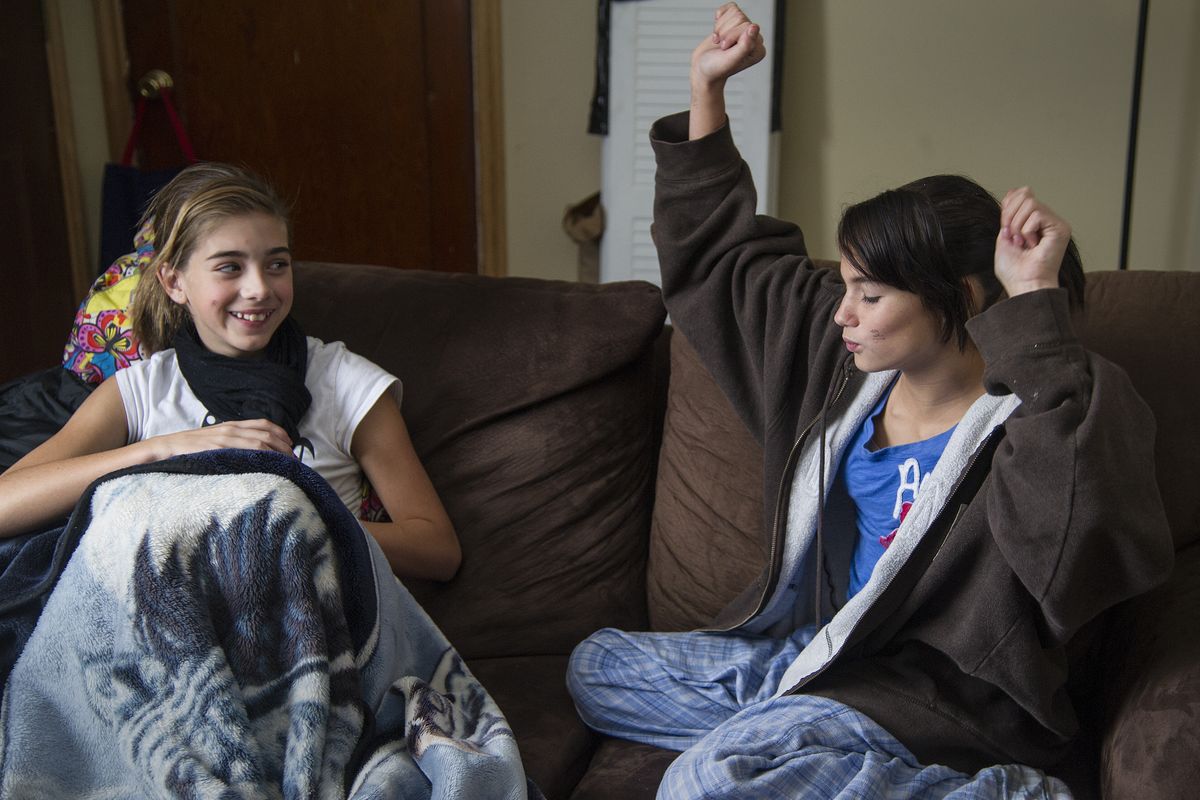 “Yeah teens,” said Caitlyn Hodges, right, who with her friend Maddie Ferry, both 13, heard the next-door neighbor’s smoke detectors going off and alerted adults. A man was quickly rescued from the burning house on East Decatur Avenue on Sunday. (Colin Mulvany)