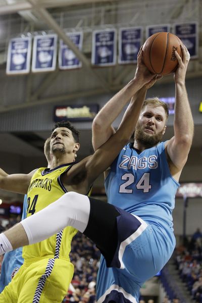 Gonzaga center Przemek Karnowski, right, will miss the rest of the season due to back surgery. (Dan Pelle / The Spokesman-Review)