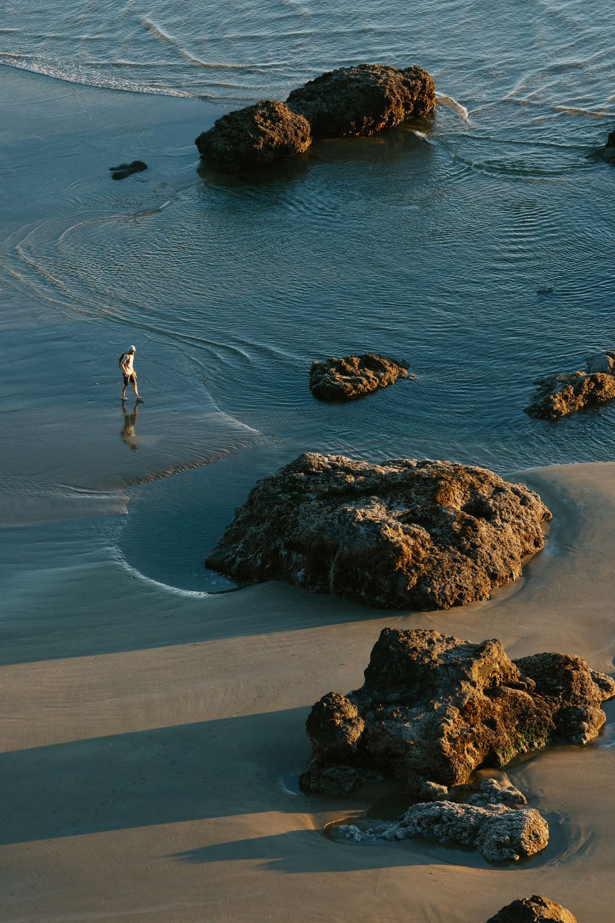A beachgoer is seen from a viewpoint at Ecola State Park in Cannon Beach, Ore., July 28, 2025. Many outdoor scenes in “The Goonies” were shot in Ecola State Park, about 25 miles southwest of Astoria.   (New York Times)